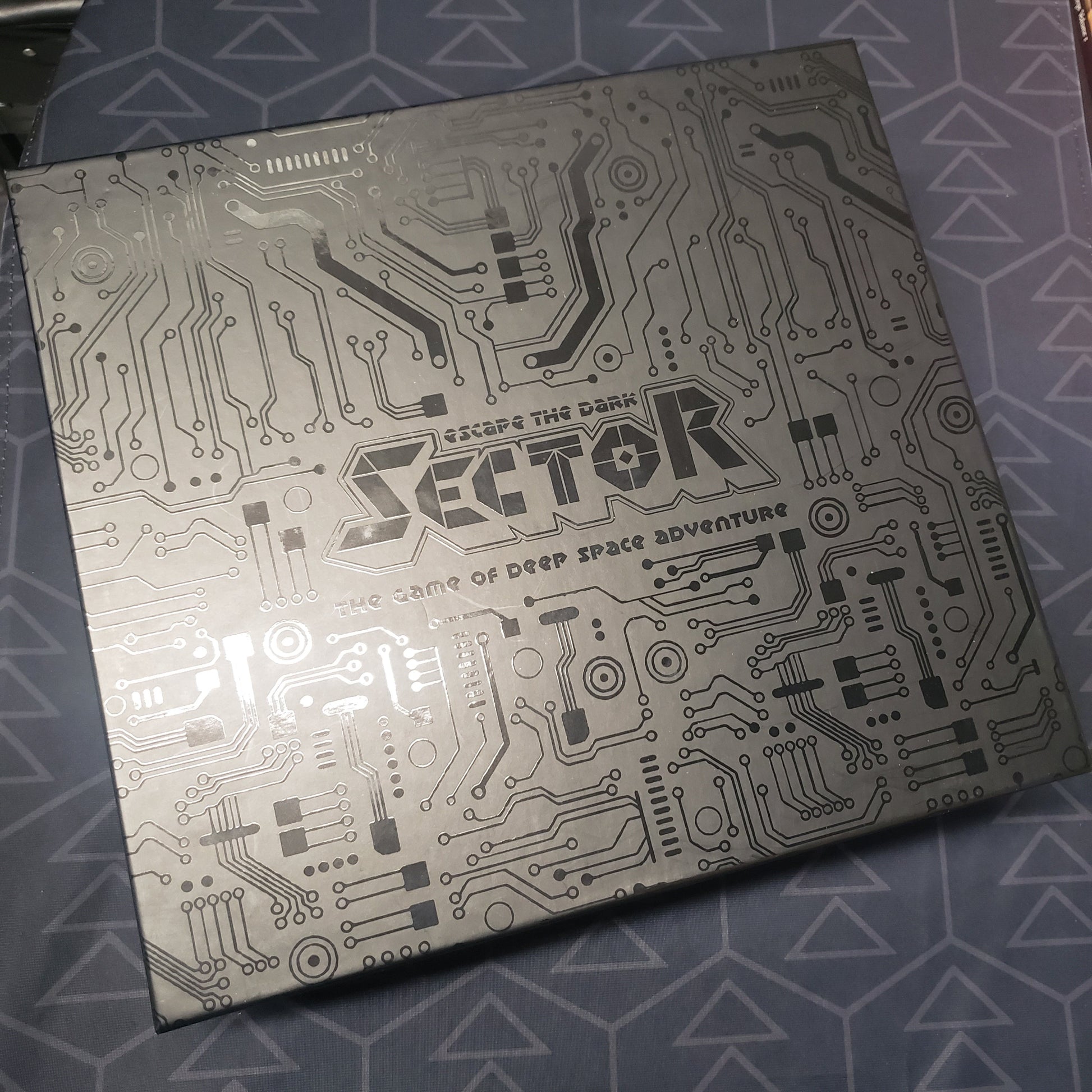 Image shows the front cover of the Collector's Box for the board game Escape the Dark Sector