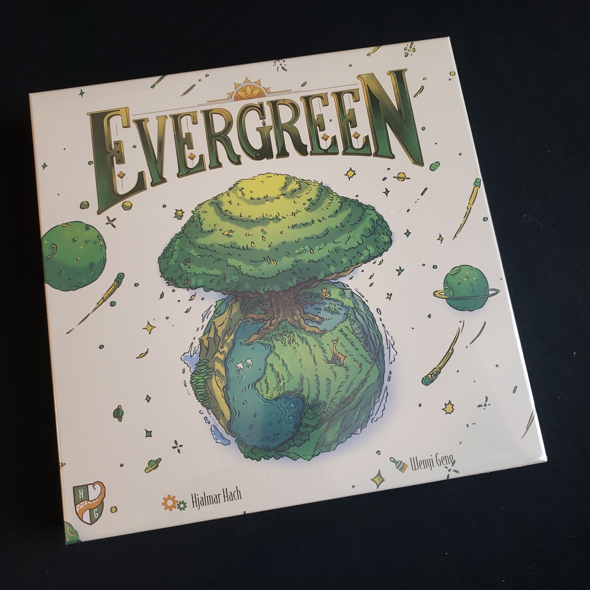 Image shows the front cover of the box of the Evergreen board game