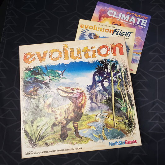 Image shows the front cover of the box of the Evolution card game sitting on top of the instructions for the Flight & Climate expansions