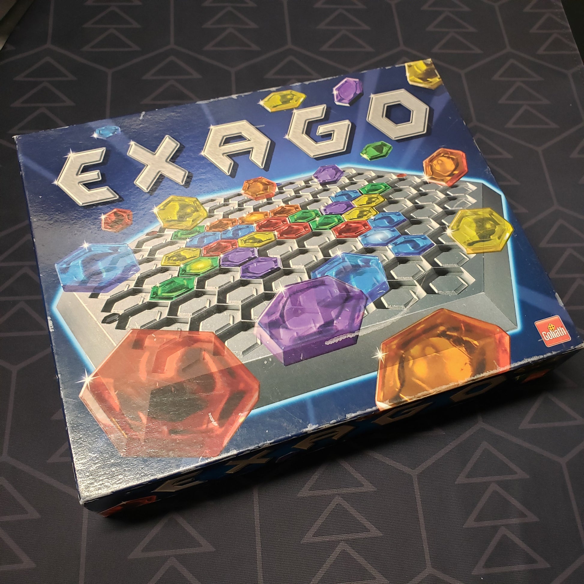 Image shows the front cover of the box for the Exago board game