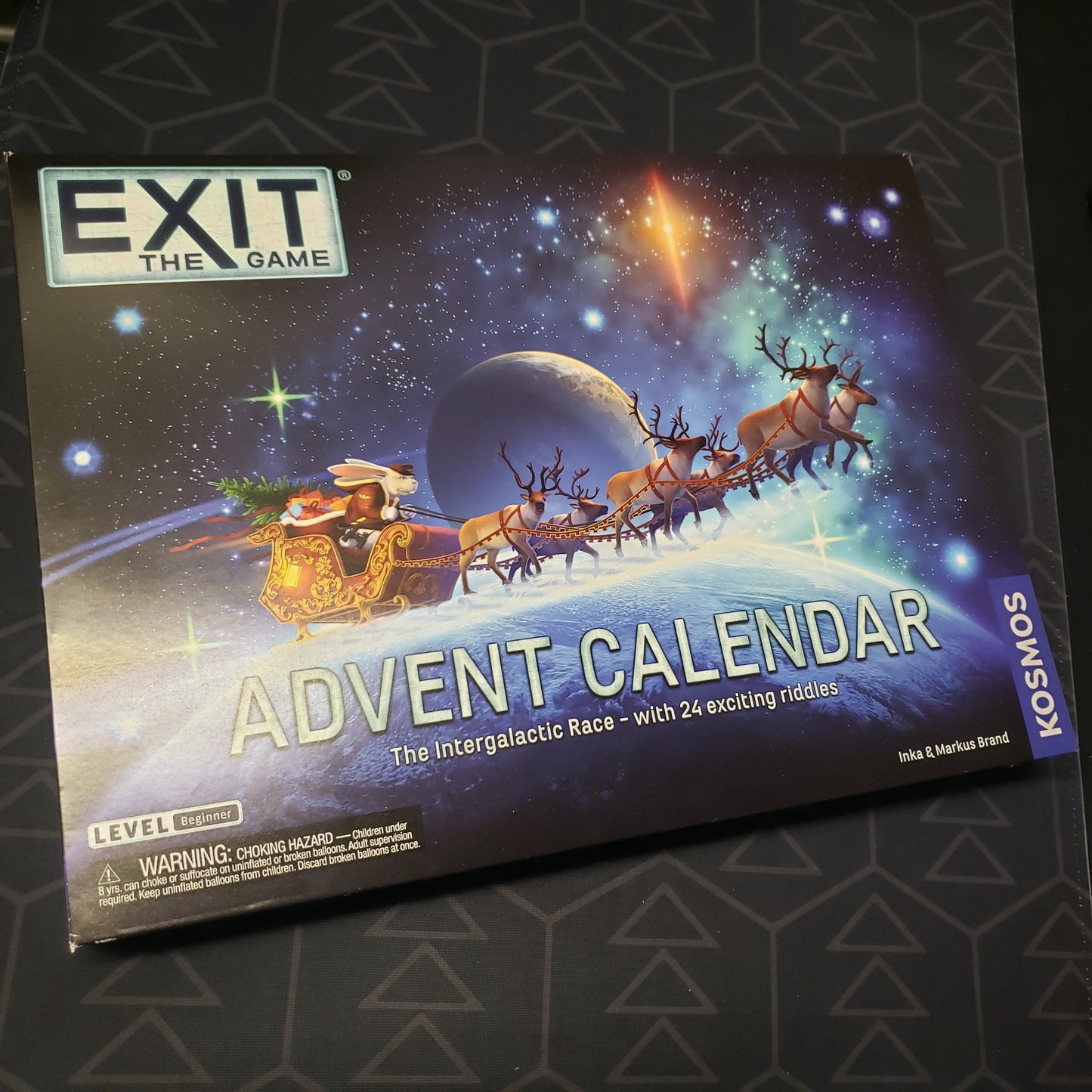 Image shows the front cover of the box for the EXIT: The Intergalactic Race Advent Calendar game