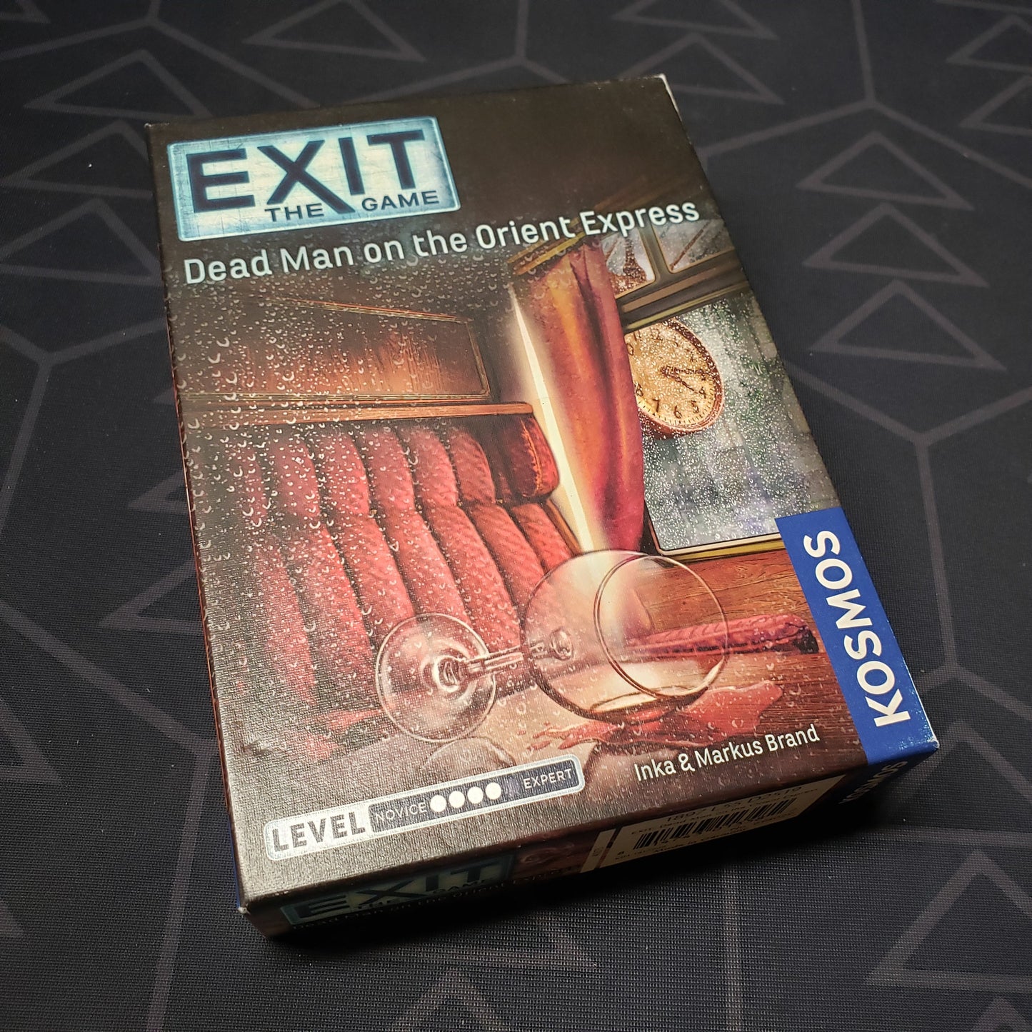 Image shows the front cover of the box for the Exit: Dead Man on the Orient Express card game