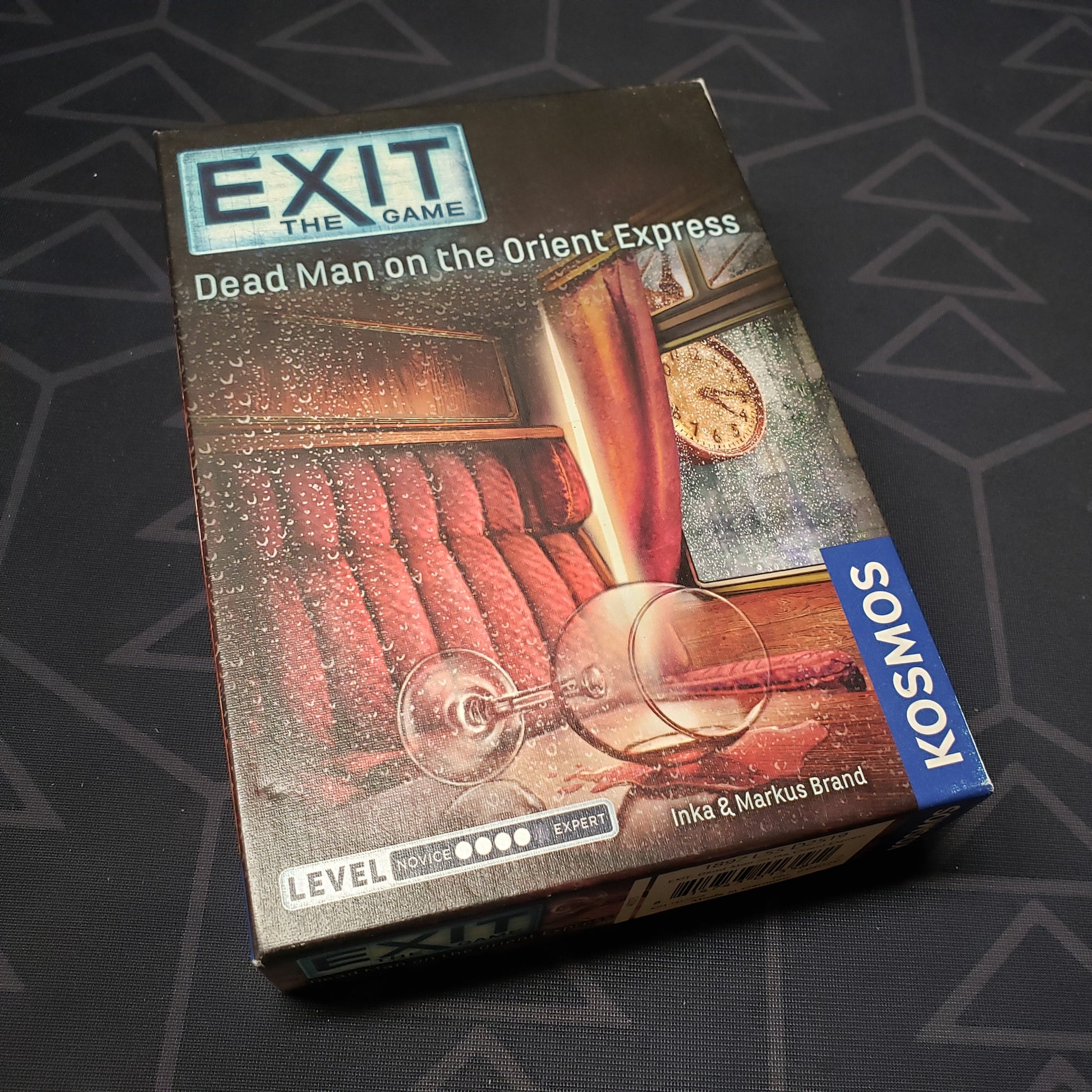 Image shows the front cover of the box for the Exit: Dead Man on the Orient Express card game
