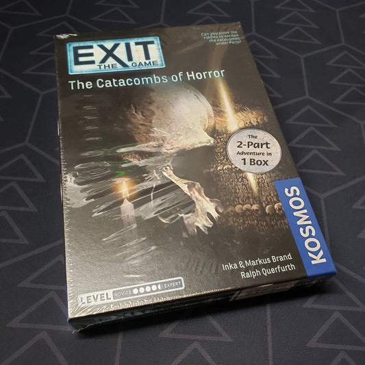 Image shows the front cover of the box of the Exit: The Catacombs of Horror board game