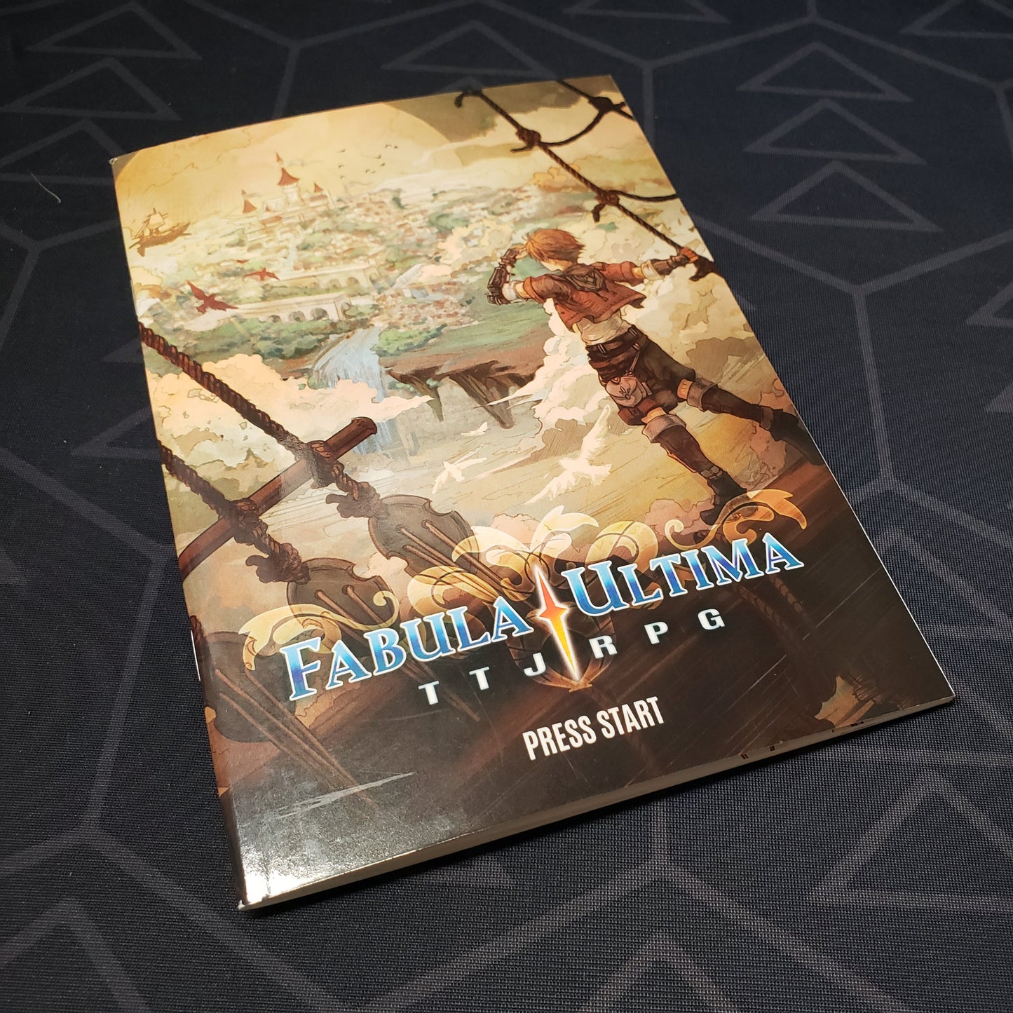 Image shows the front cover of the Press Start book for the roleplaying game Fabula Ultima