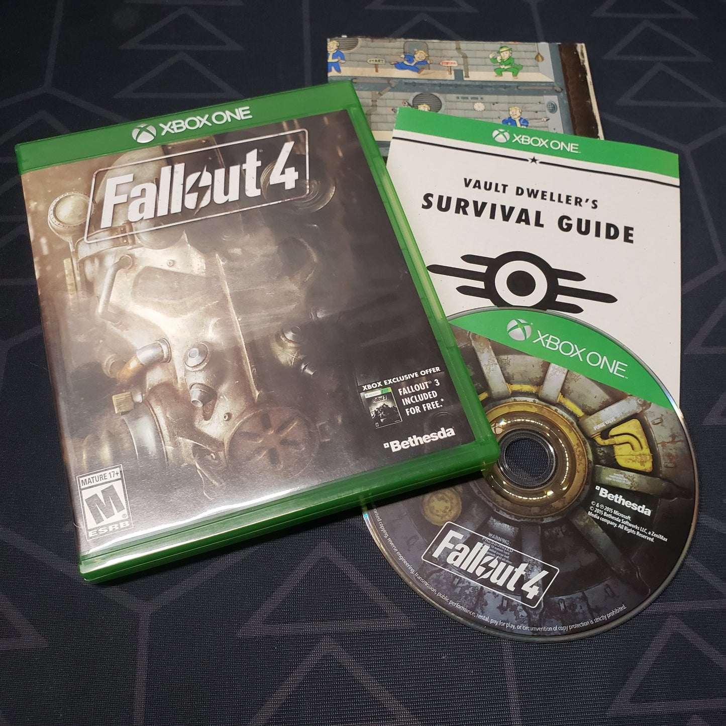 Image shows the case, manual, folded poster and disc for the video game Fallout 4 for Xbox One
