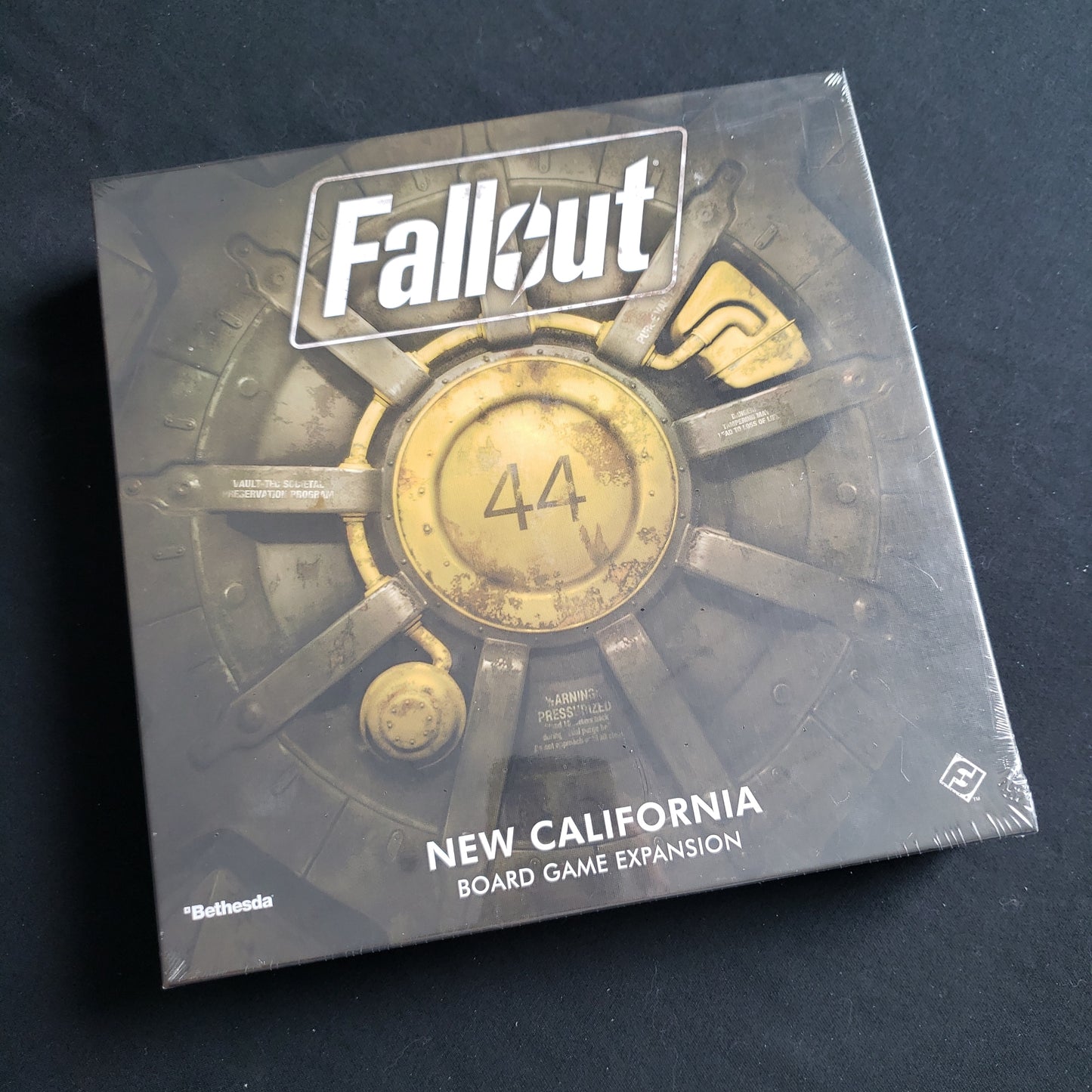 Image shows the front cover of the box of the New California expansion for the Fallout board game