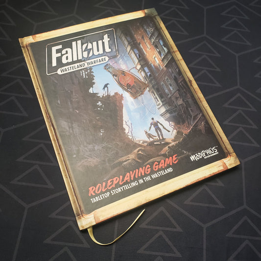 Image shows the front cover of the core rulebook for the Fallout: Wasteland Warfare Roleplaying Game