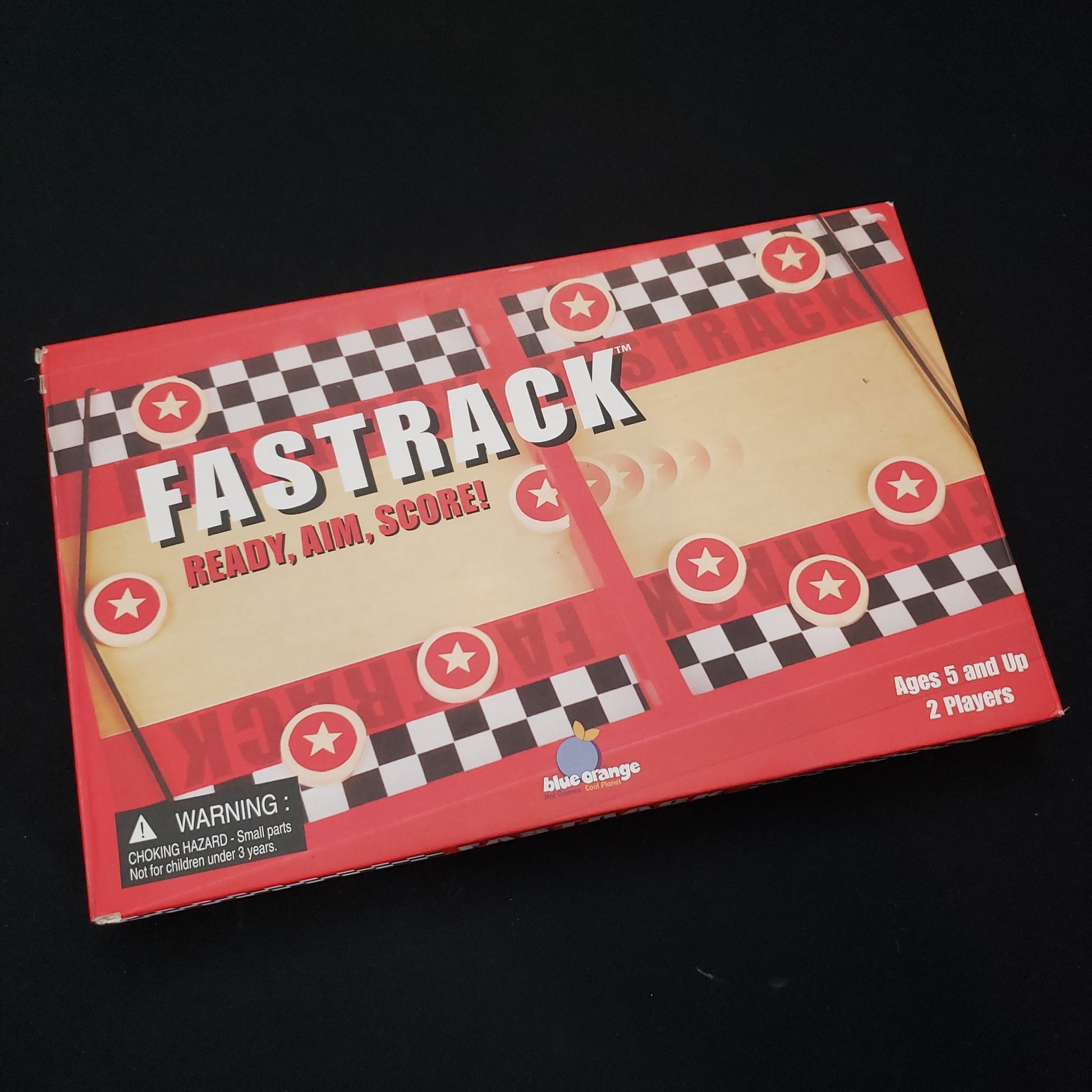 Image shows the front cover of the box of the Fastrack board game