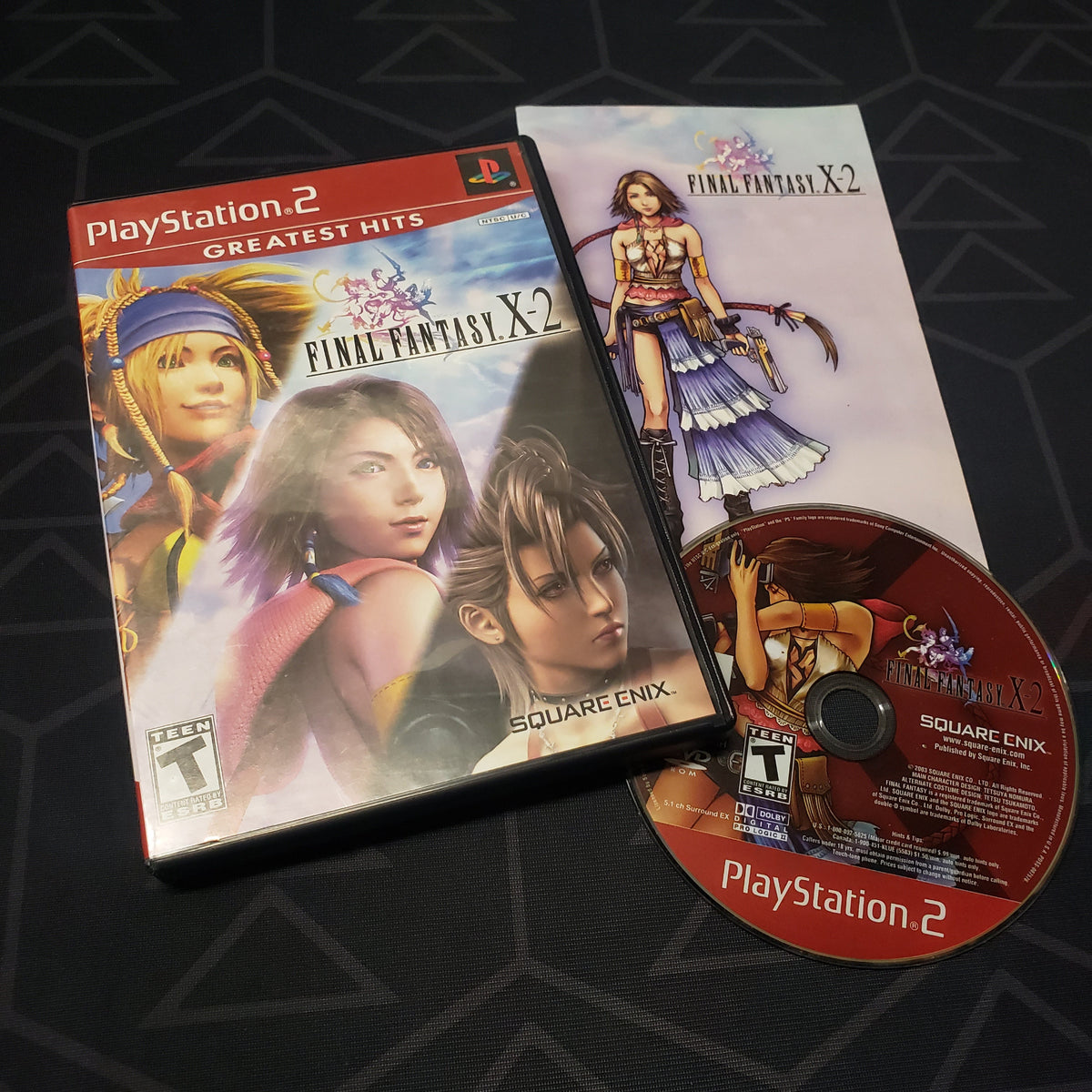Image shows the case, manual and disc for the video game Final Fantasy X-2 for Playstation 2