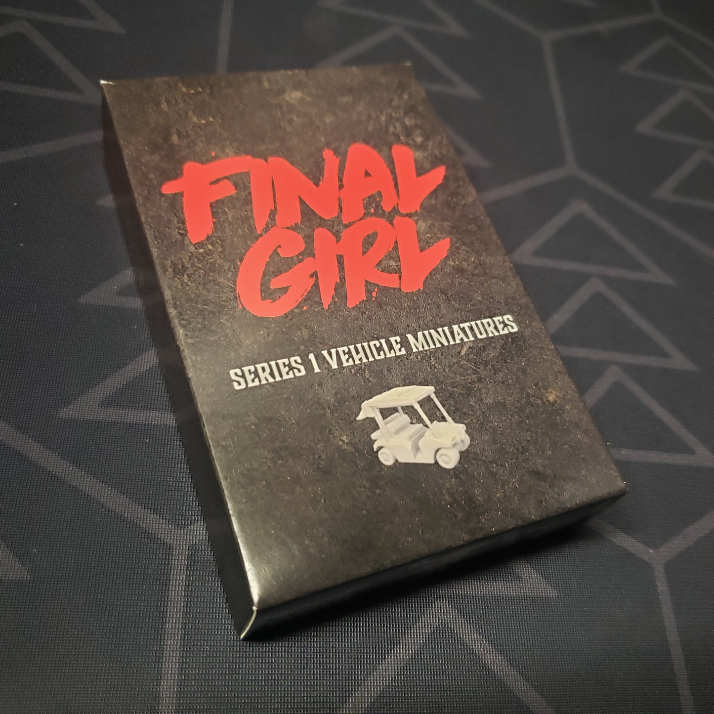 Image shows the front cover of the box of the Series 1 Vehicle Miniatures expansion for the board game Final Girl