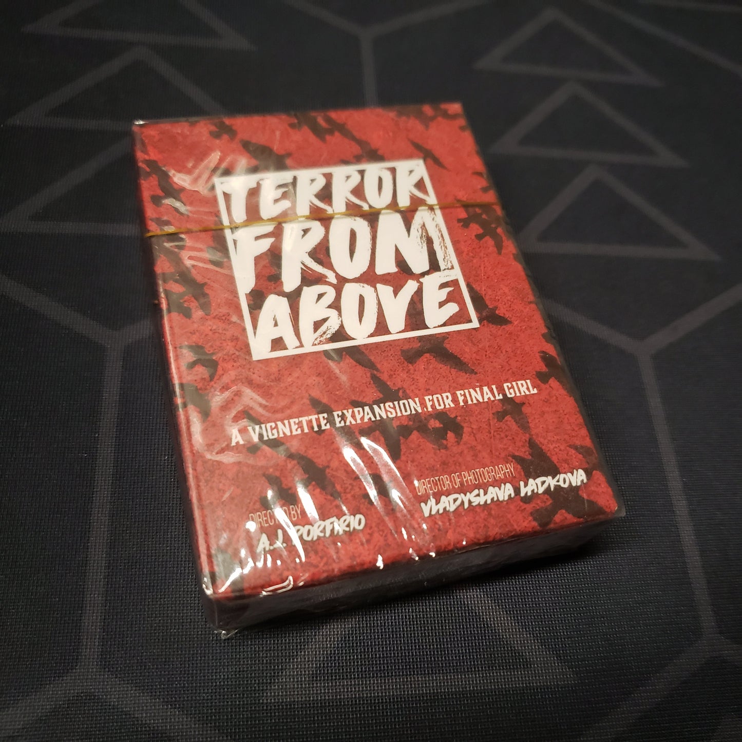 Image shows the front cover of the box of the Terror From Above expansion for the board game Final Girl