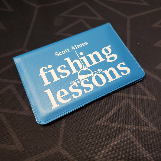 Image shows the front of the card wallet for the Fishing Lessons card game