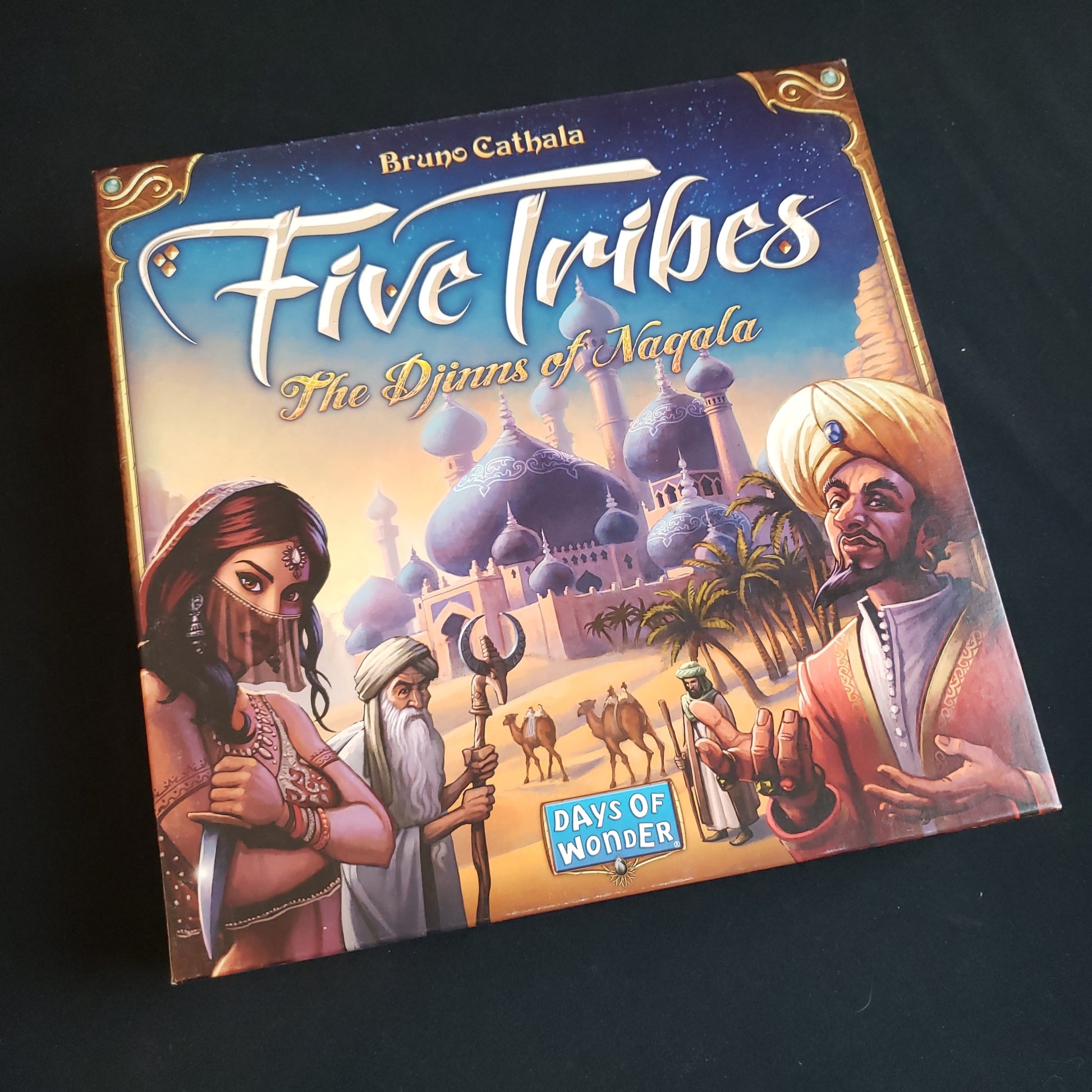 Image shows the front cover of the box of the Five Tribes board game