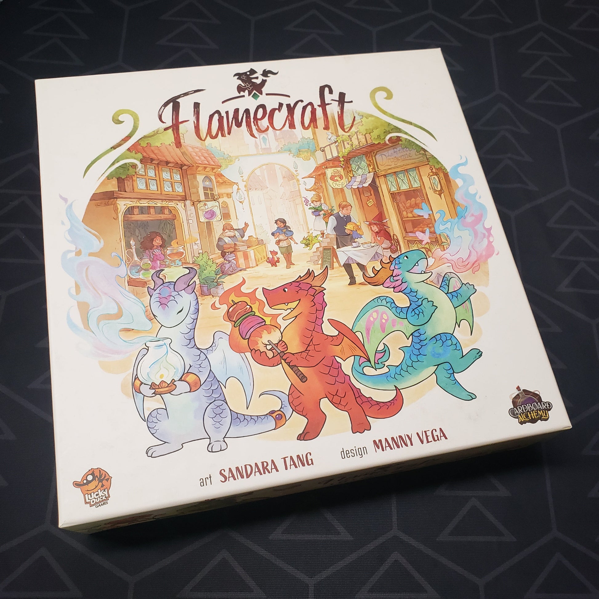 Image shows the front cover of the box of the Flamecraft board game
