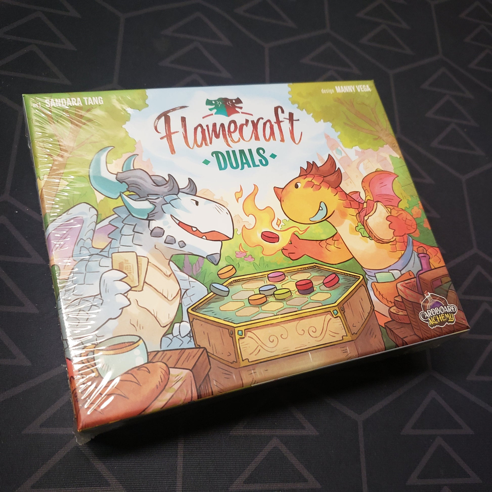 Image shows the front cover of the box for the Flamecraft Duals board game