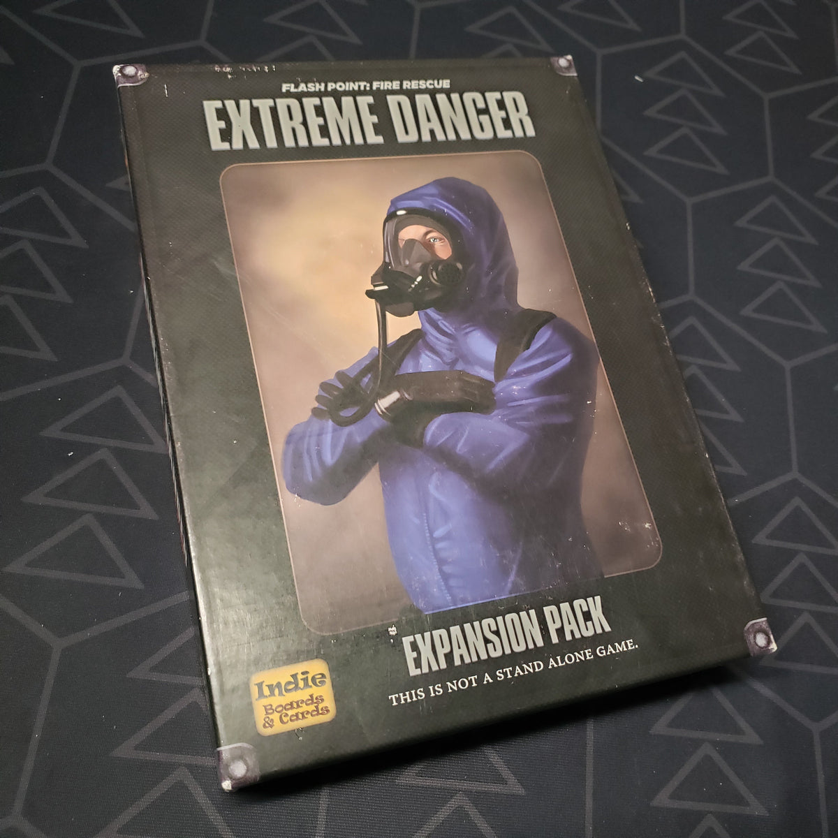 Image shows the front cover of the box of the Extreme Danger expansion for the board game Flash Point: Fire Rescue