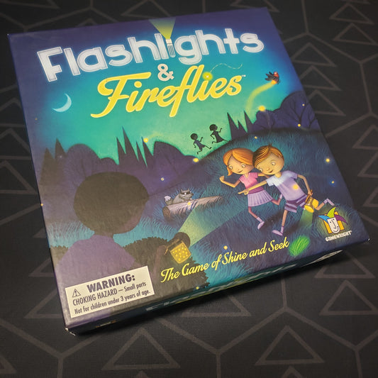 Image shows the front cover of the box for the Flashlights & Fireflies board game