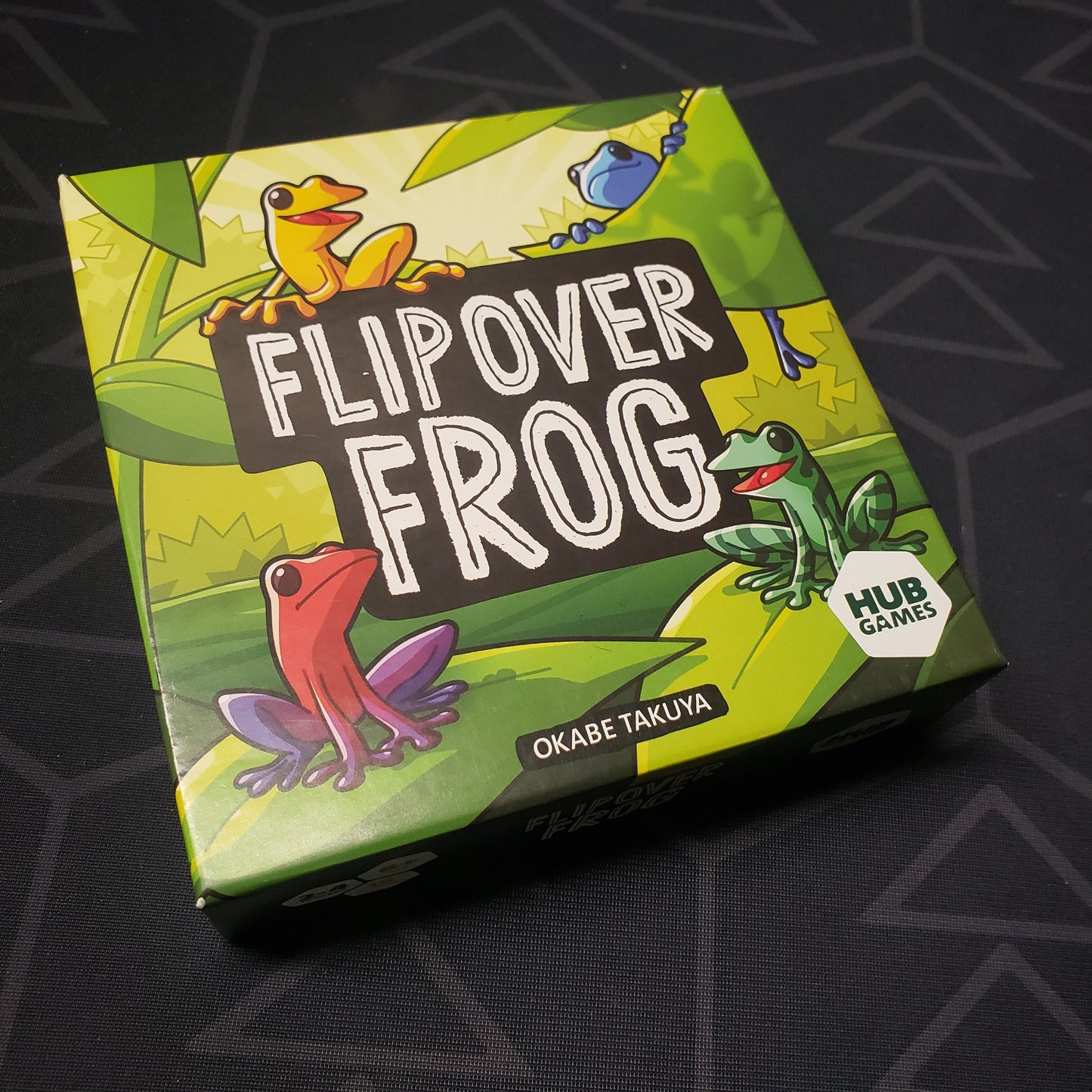 Image shows the front cover of the box for the Flip Over Frog board game