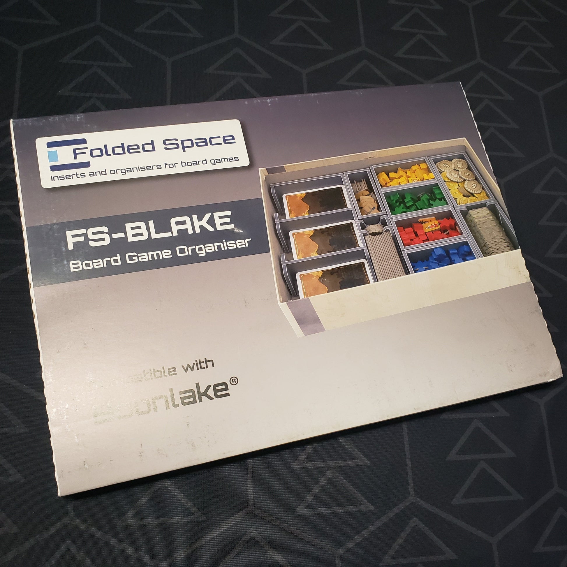 Image shows the front cover of the box for the Folded Space Insert for the board game Boonlake