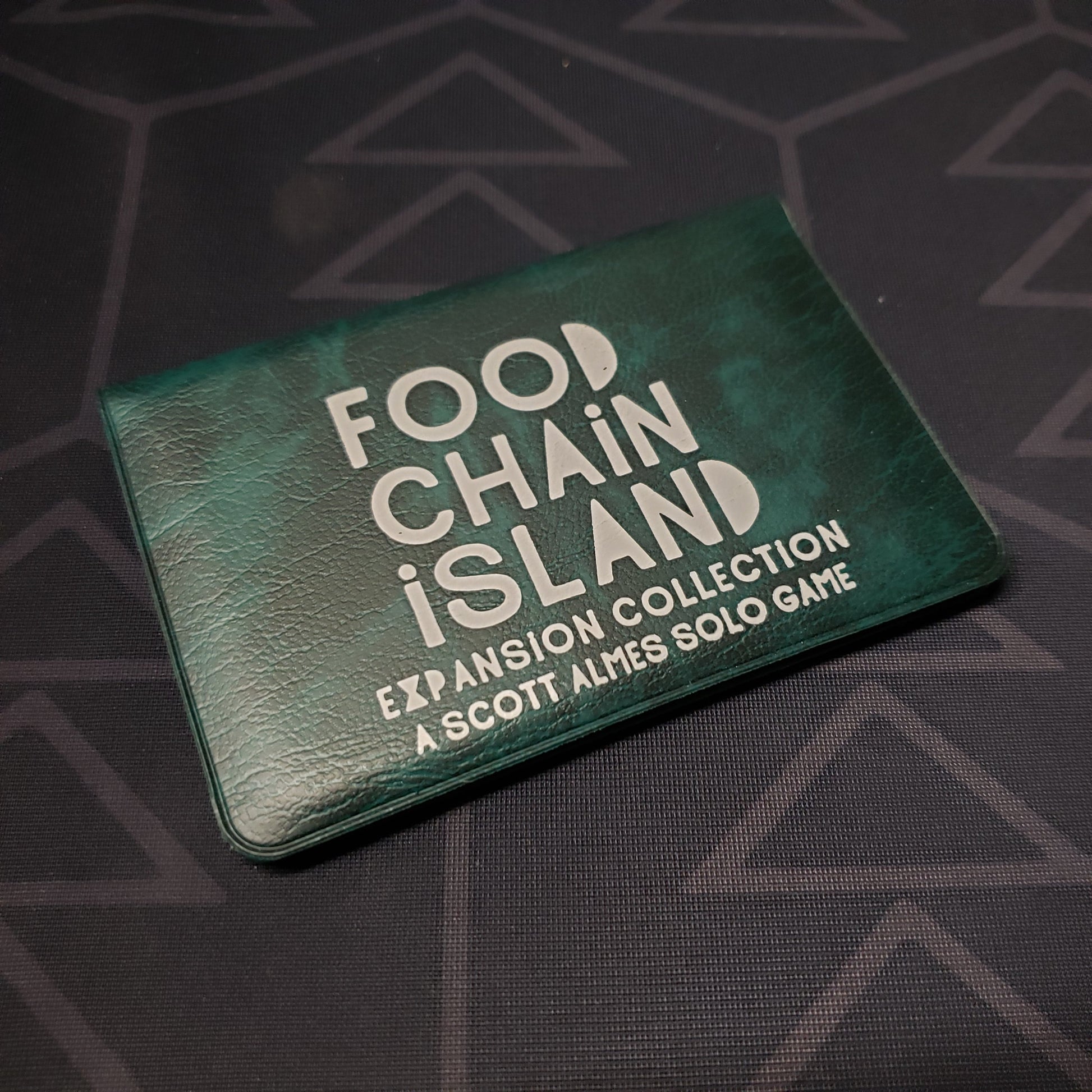 Image shows the front of the card wallet of the Expansion Collection for the card game Food Chain Island