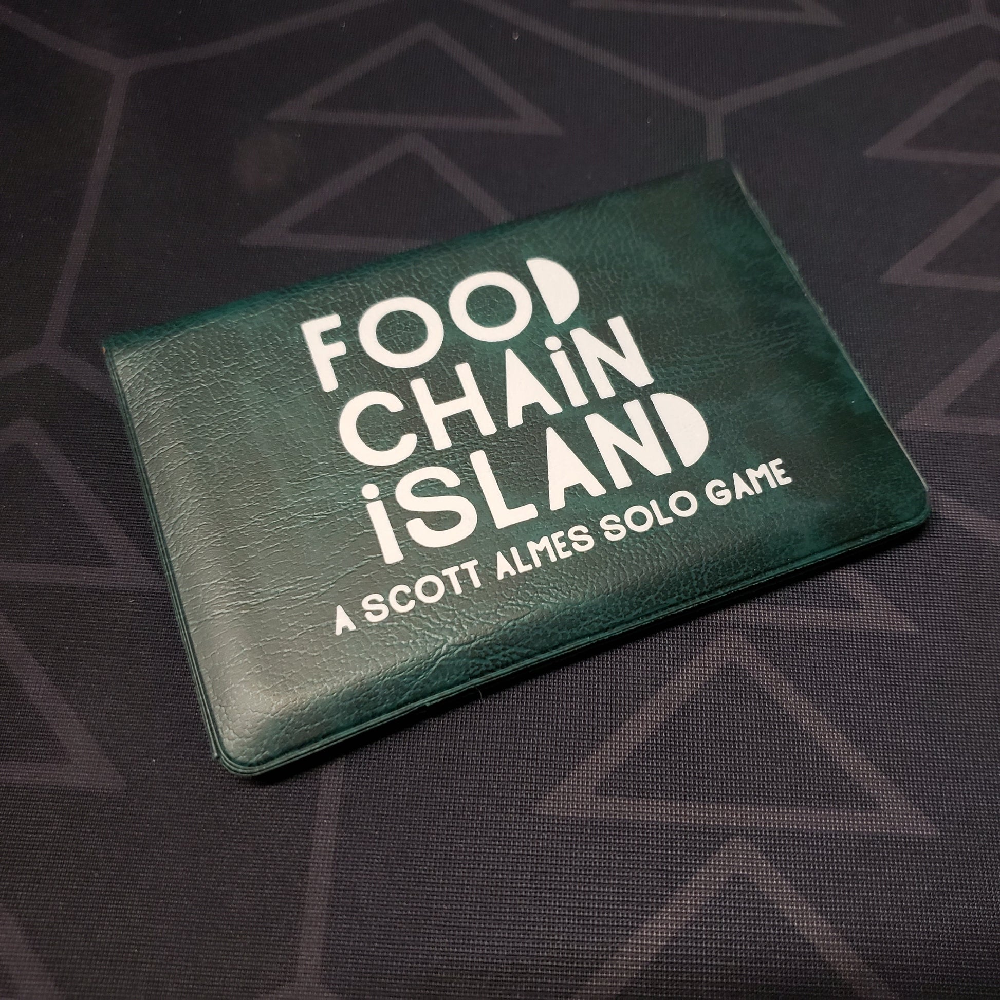 Image shows the front of the card wallet for the Food Chain Island card game