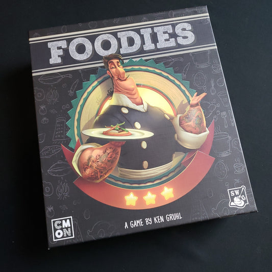 Image shows the front cover of the box of the Foodies board game