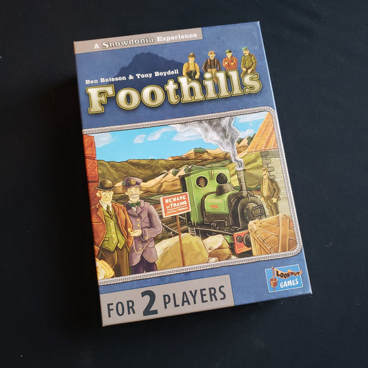 Image shows the front cover of the box of the Foothills board game