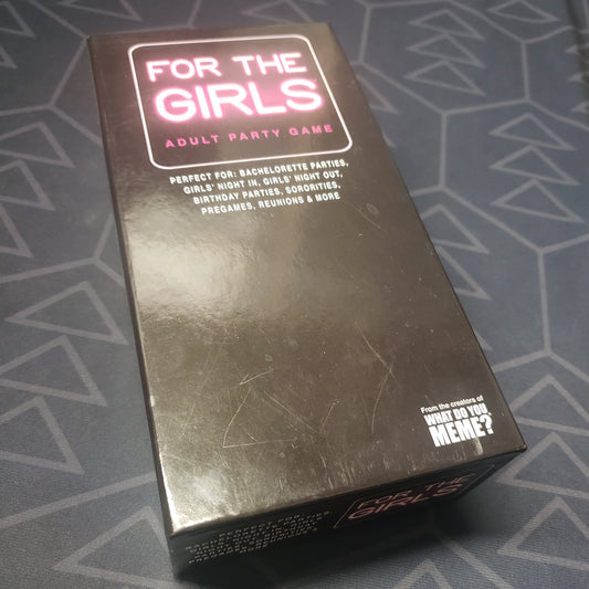 Image shows the front cover of the box for the card game For the Girls