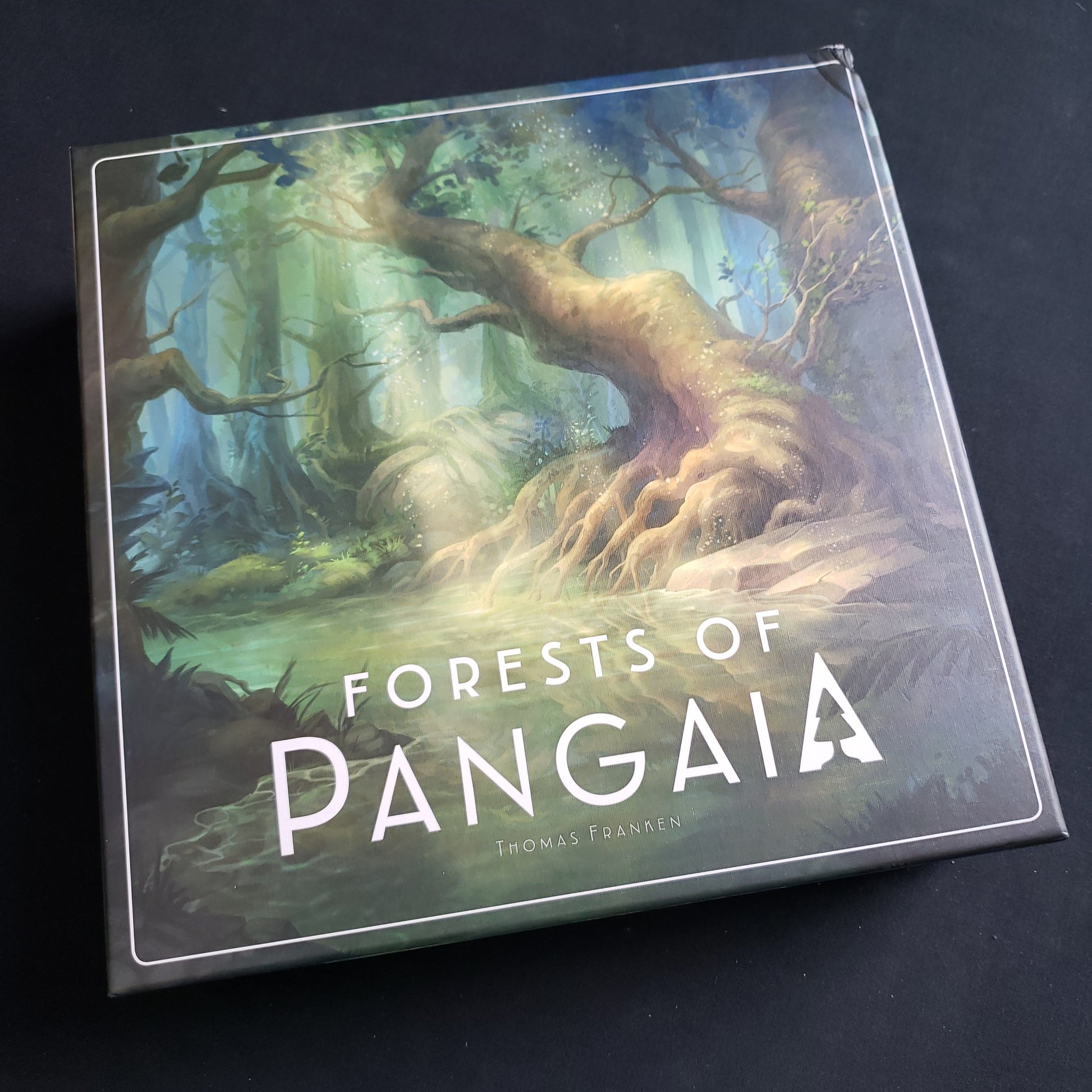 Image shows the front cover of the box of the Forests of Pangaia board game