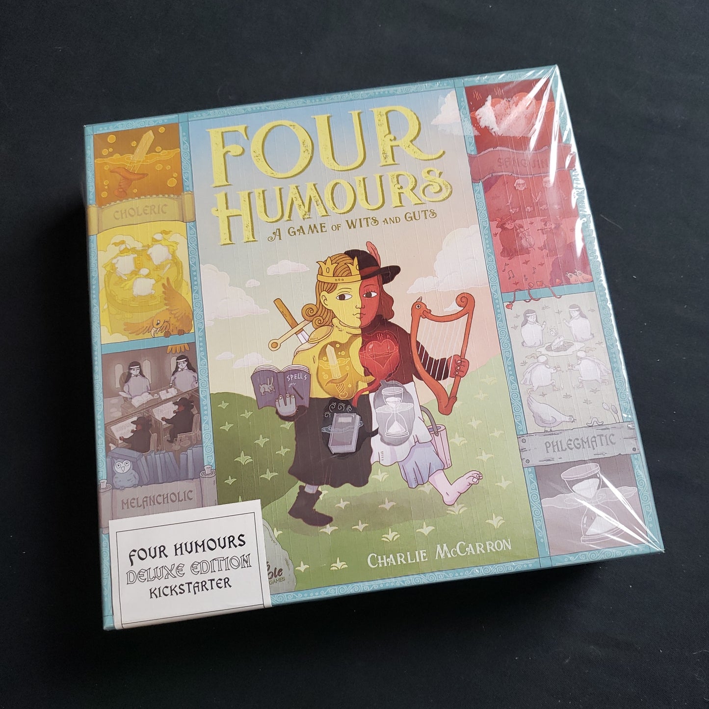 Image shows the front cover of the box of the Four Humours board game