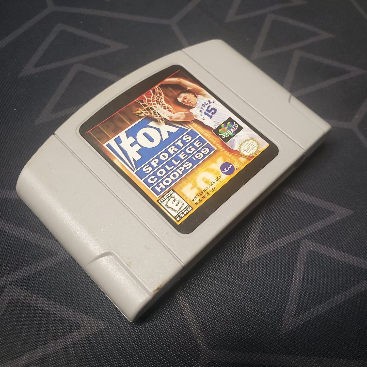 Image shows the front of the cartridge for the video game Fox Sports College Hoops '99 for the Nintendo 64