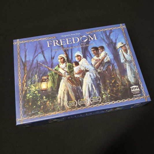 Image shows the front cover of the box of the Freedom: The Underground Railroad board game