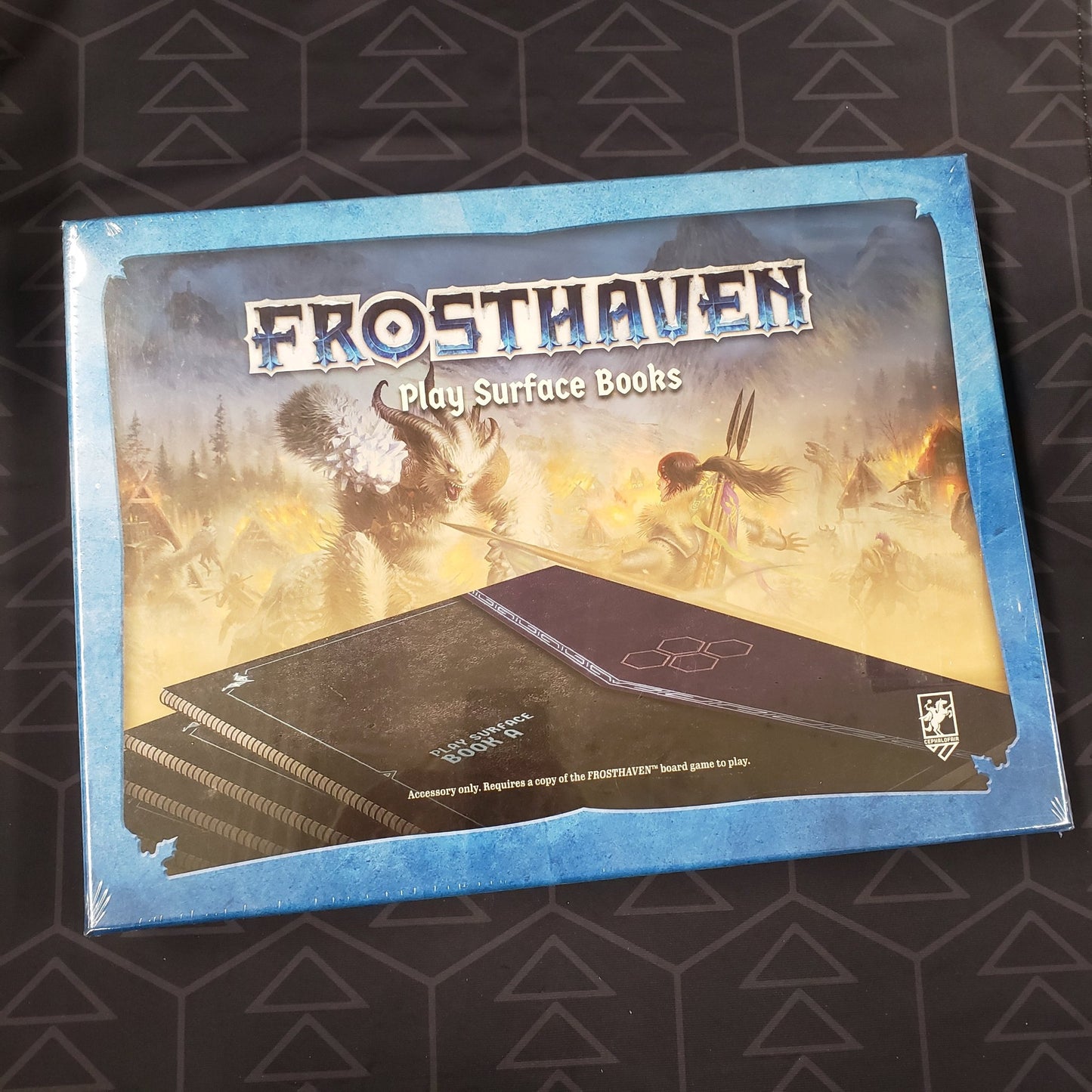 Image shows the front cover of the box of the Frosthaven: Play Surface Books