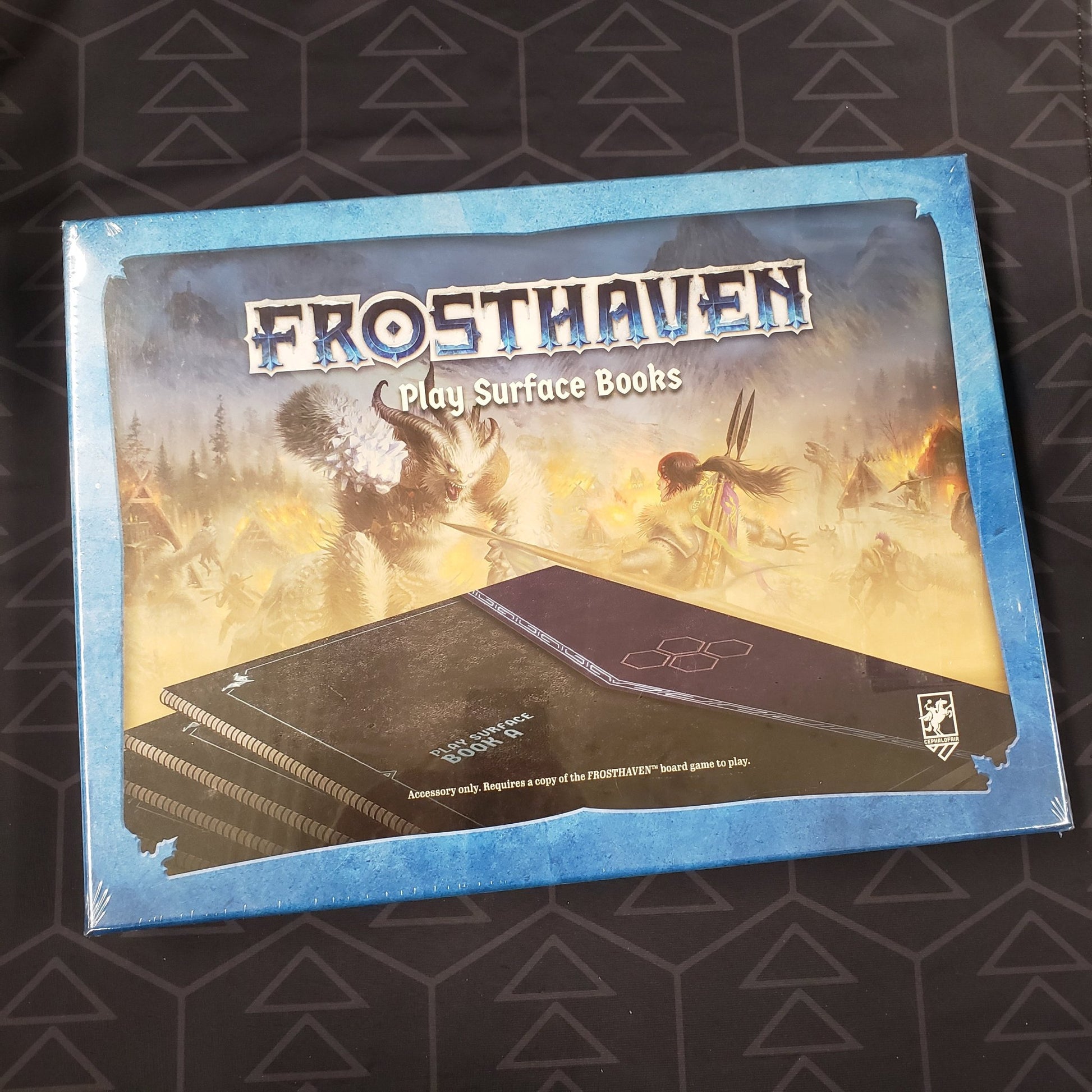Image shows the front cover of the box of the Frosthaven: Play Surface Books