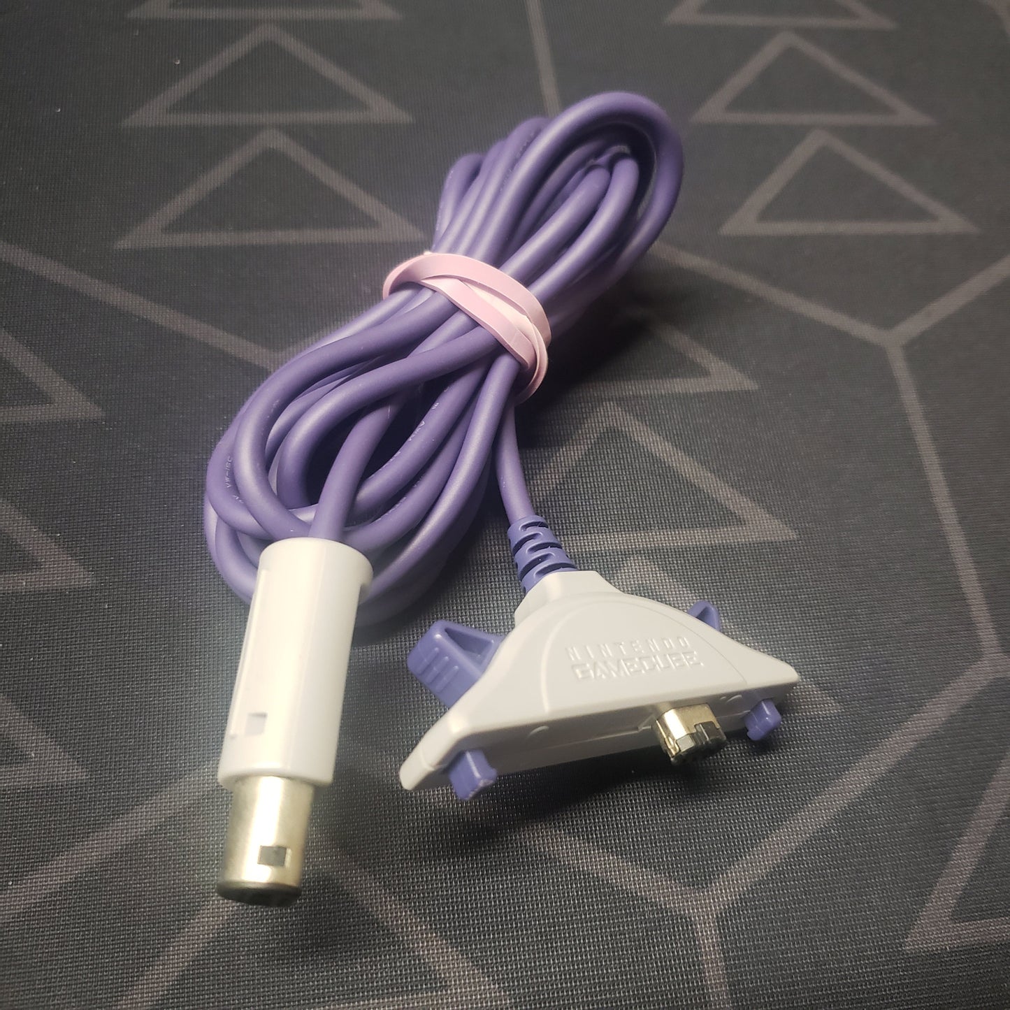 Image shows a GameCube Gameboy Advance Link Cable wrapped in a rubber band
