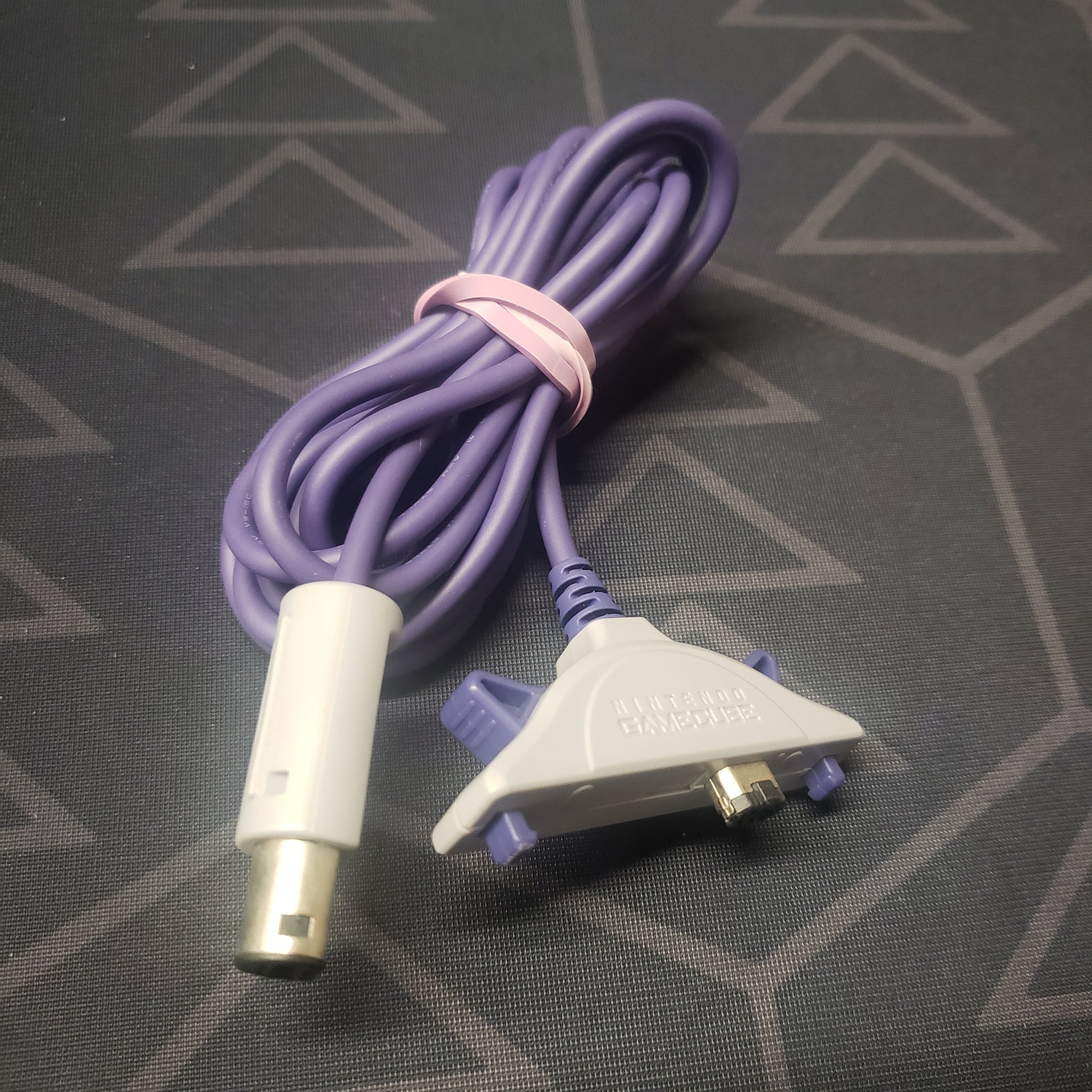 Image shows a GameCube Gameboy Advance Link Cable wrapped in a rubber band