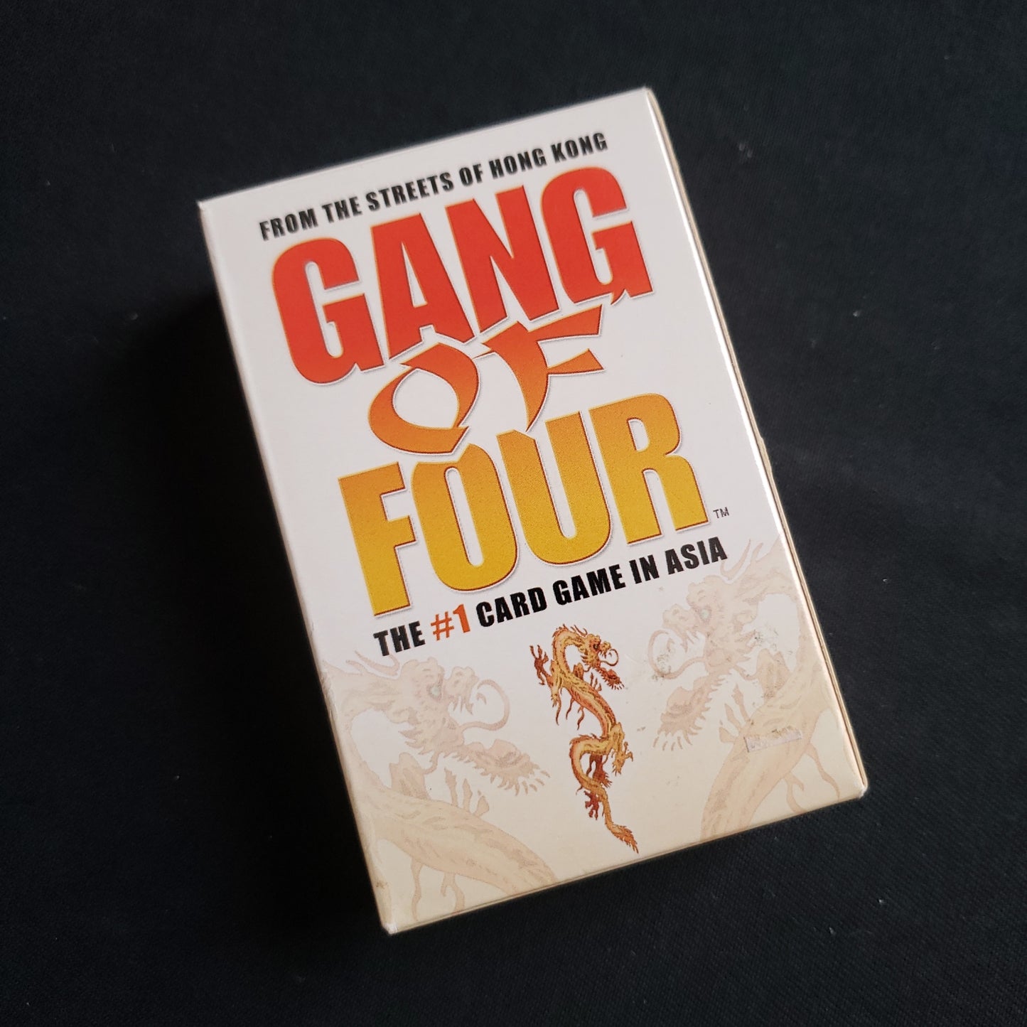 Image shows the front cover of the box of the Gang of Four card game