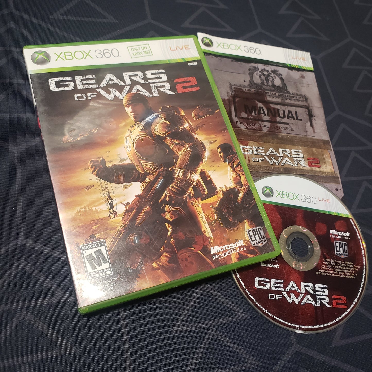 Image shows the case, manual and disc for the video game Gears of War 2 for Xbox 360