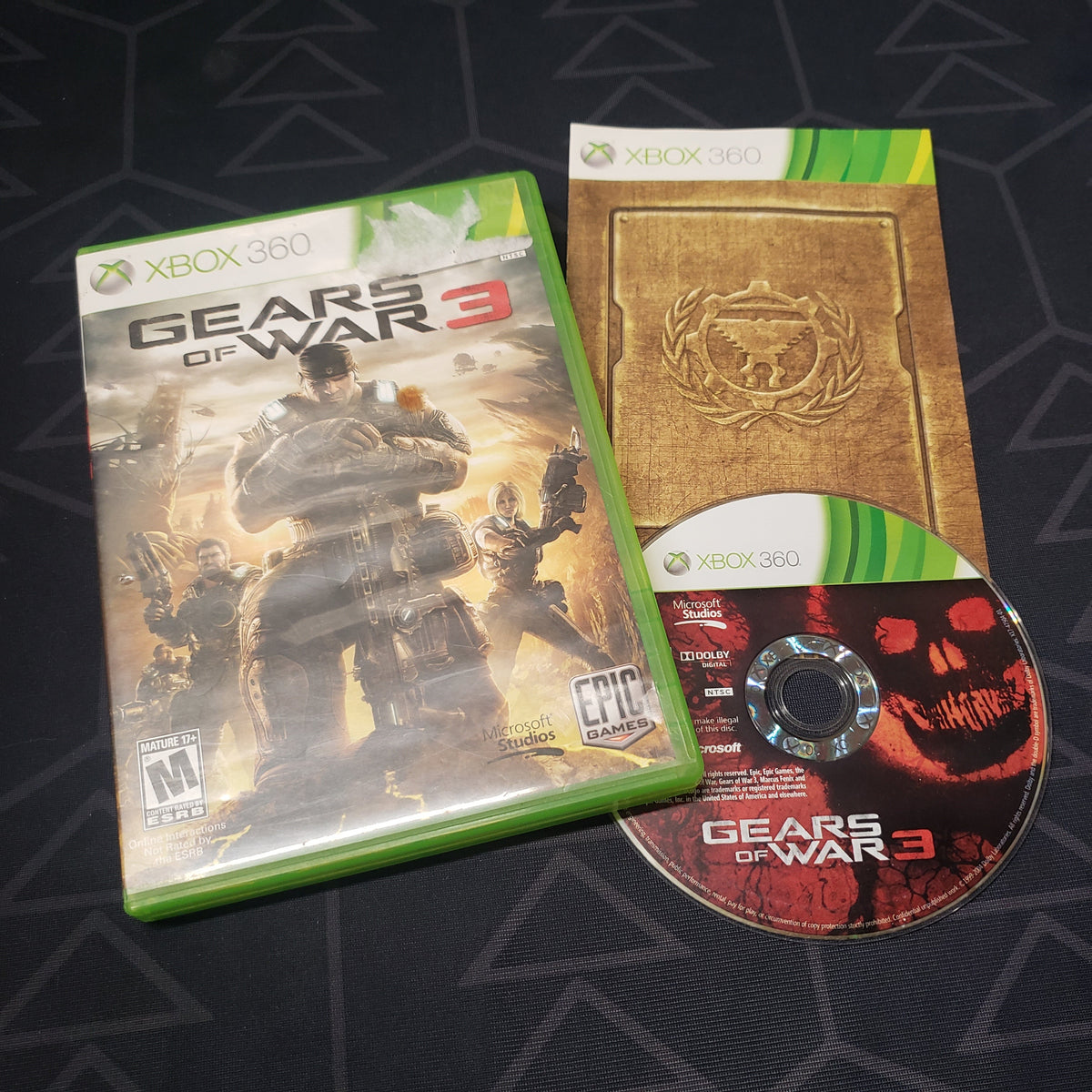 Image shows the case, manual and disc for the video game Gears of War 3 for Xbox 360