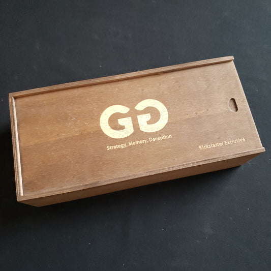 Image shows the front cover of the box of the Kickstarter Exclusive edition of the card game GG
