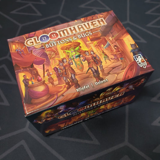 Image shows the front cover of the box for the Gloomhaven: Buttons & Bugs board game