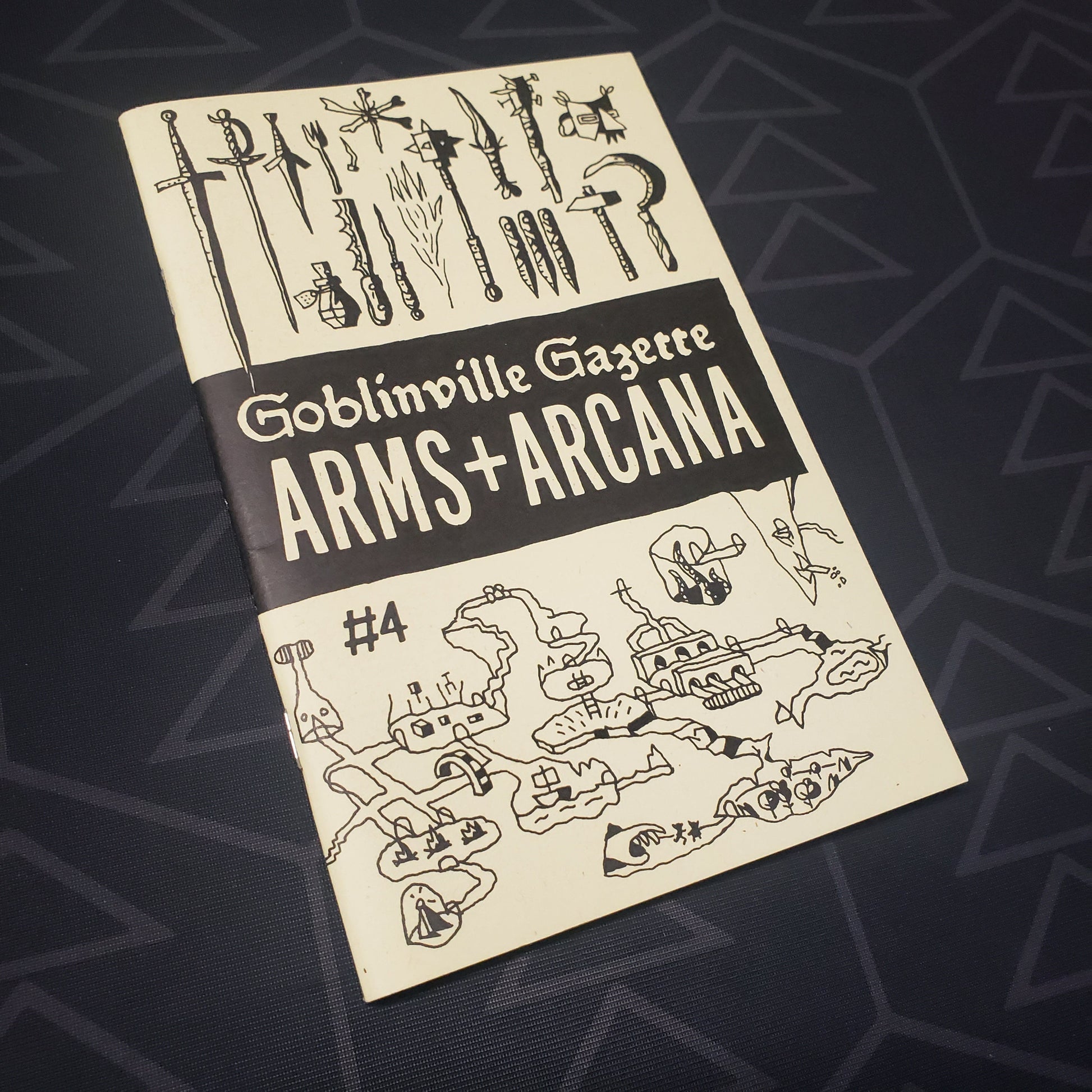 Image shows the front cover of the Goblinville Gazette #4: Arms & Arcana roleplaying game book
