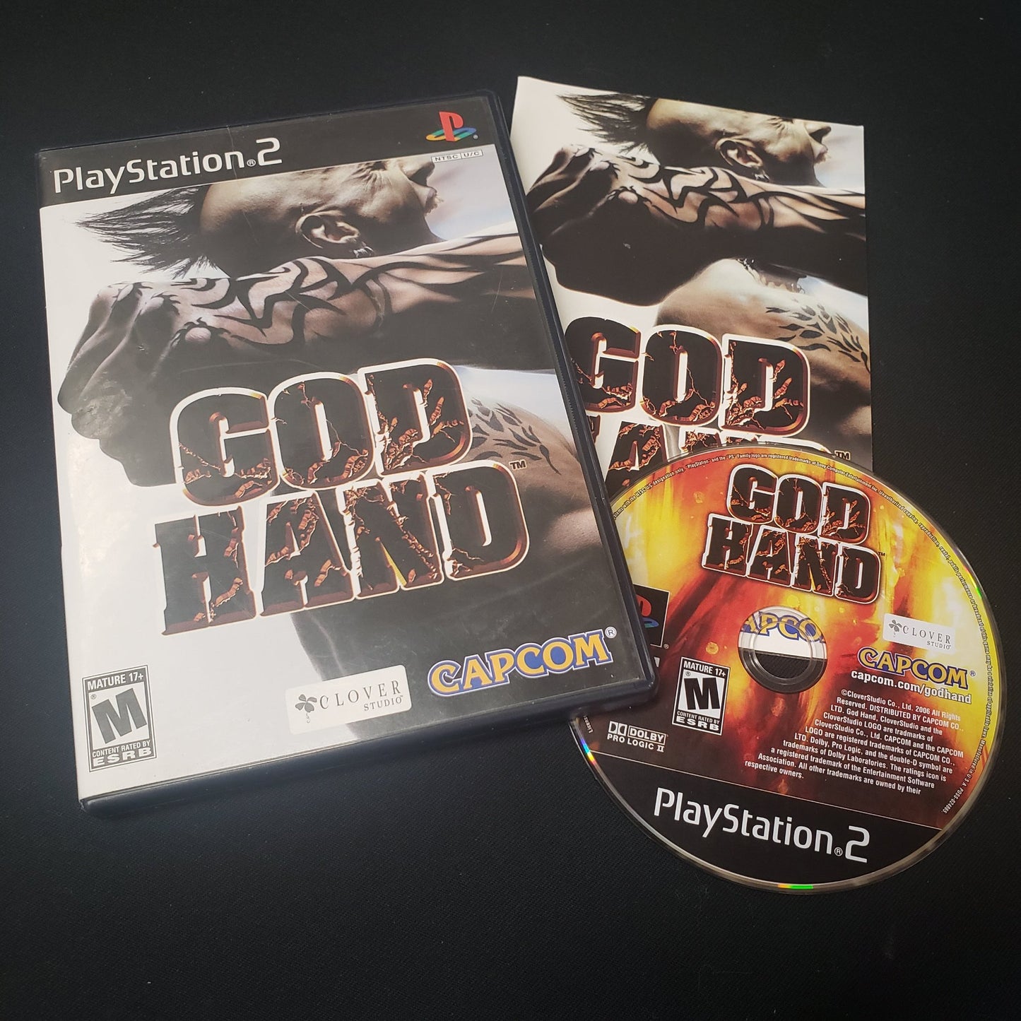 Image shows the case, disc and manual for the PS2 game God Hand