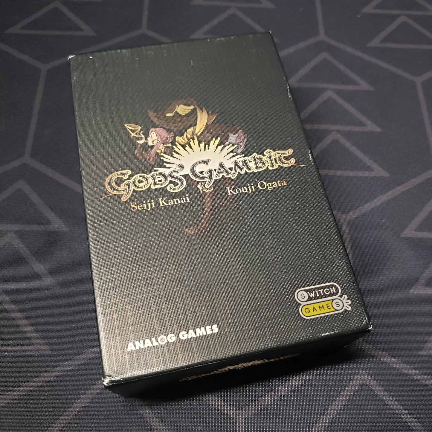 Image shows the front cover of the box for the Gods' Gambit card game