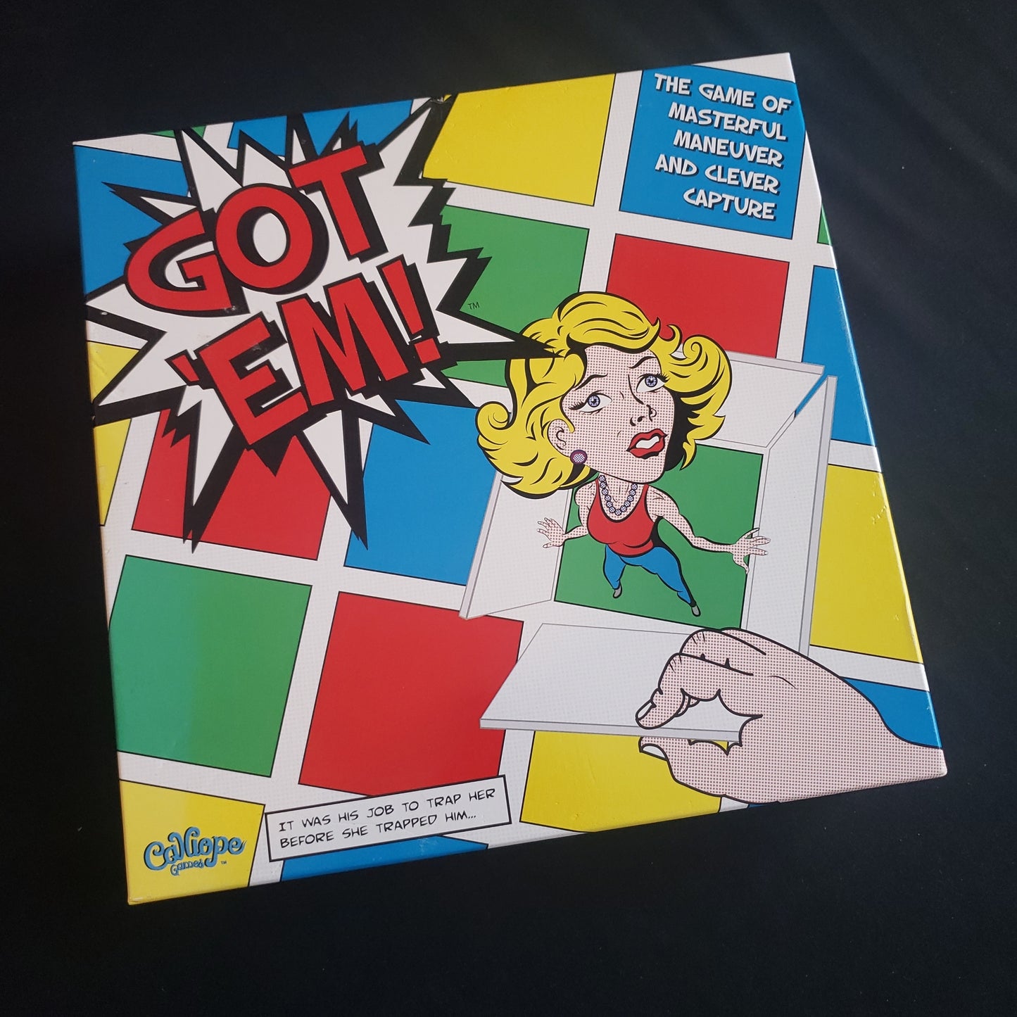 Image shows the front cover of the box of the Got 'Em! board game