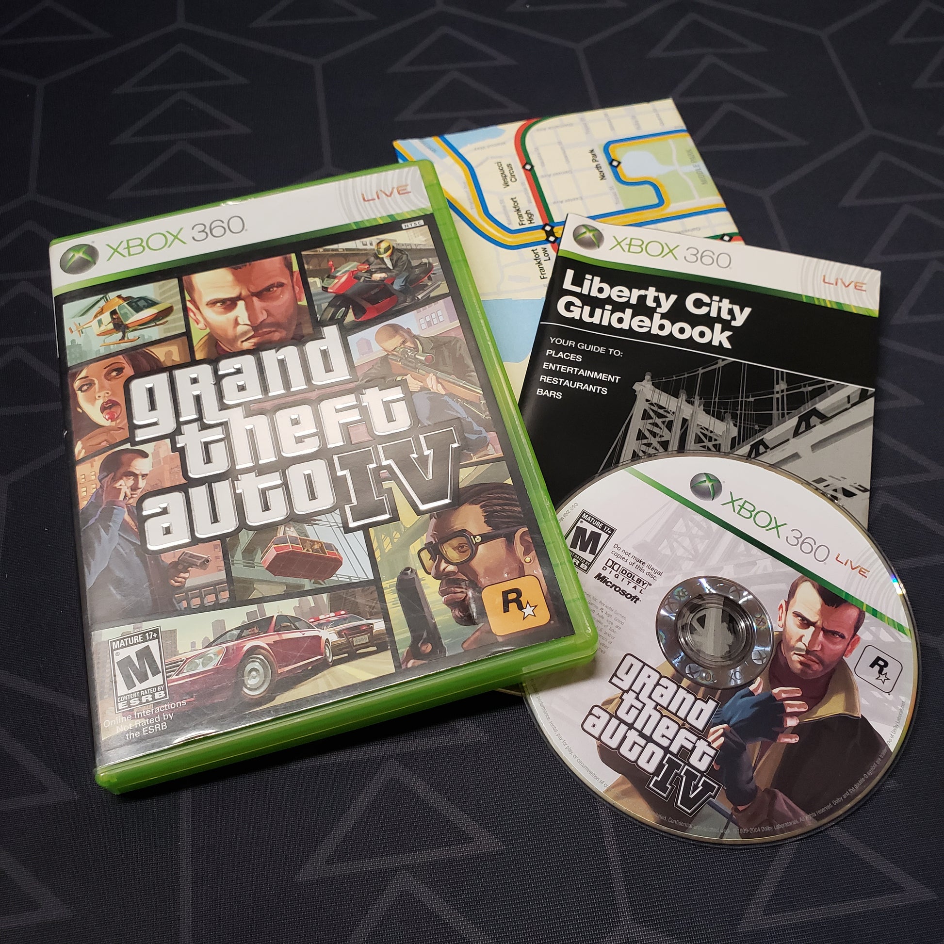 Image shows the case, manual, poster map and disc for the video game Grand Theft Auto IV for Xbox 360