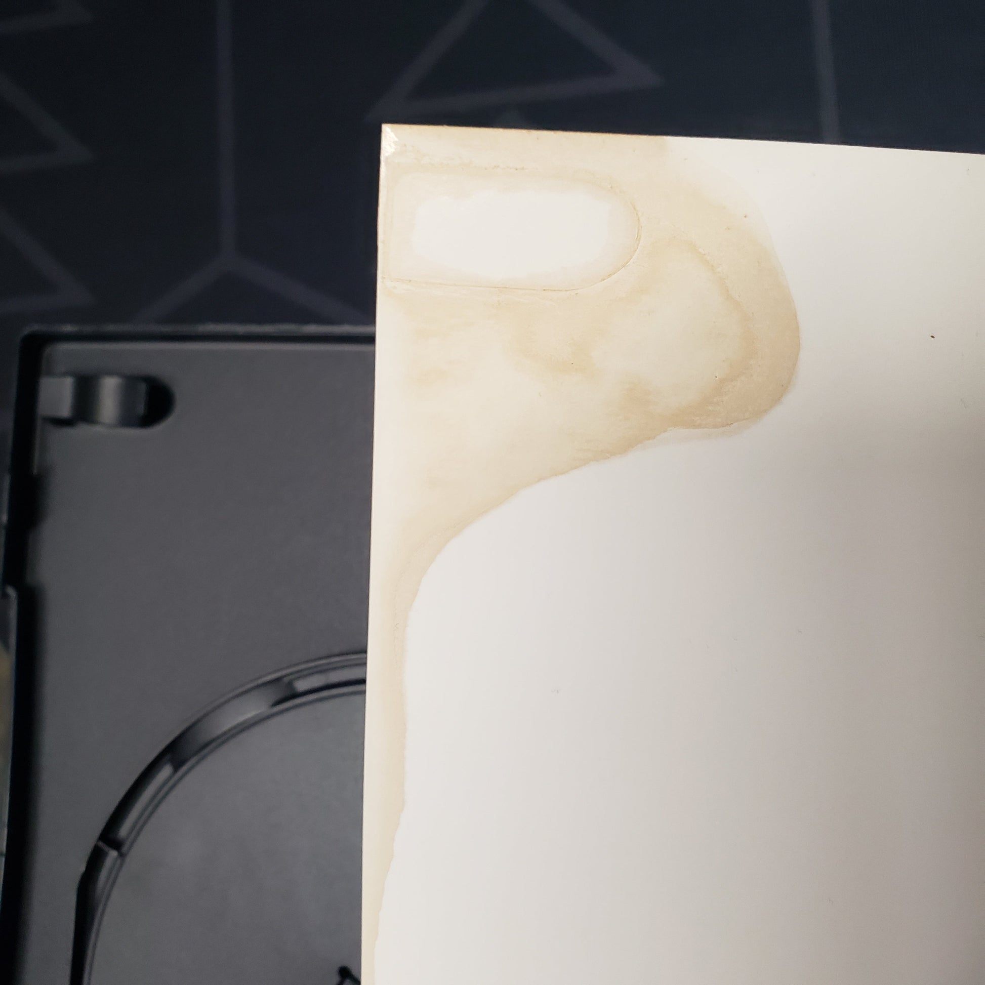 Image shows some discoloration on the inside of the case artwork for a Playstation 2 game