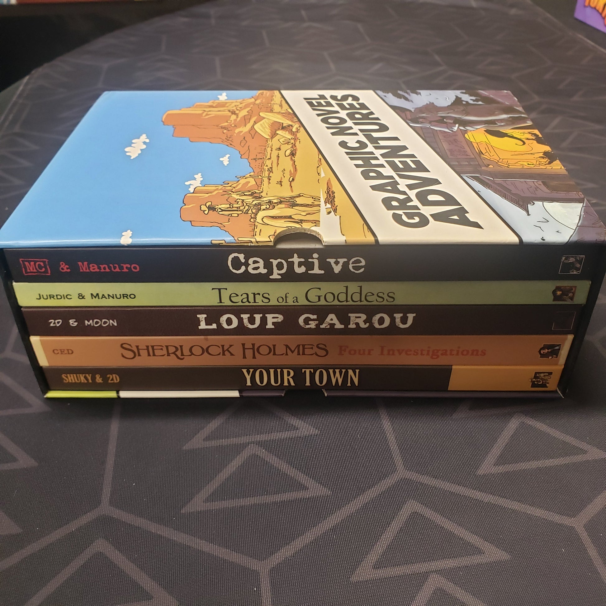 Image shows the spines of the five books in the Graphic Novel Adventures: Season 1 gaming book box set