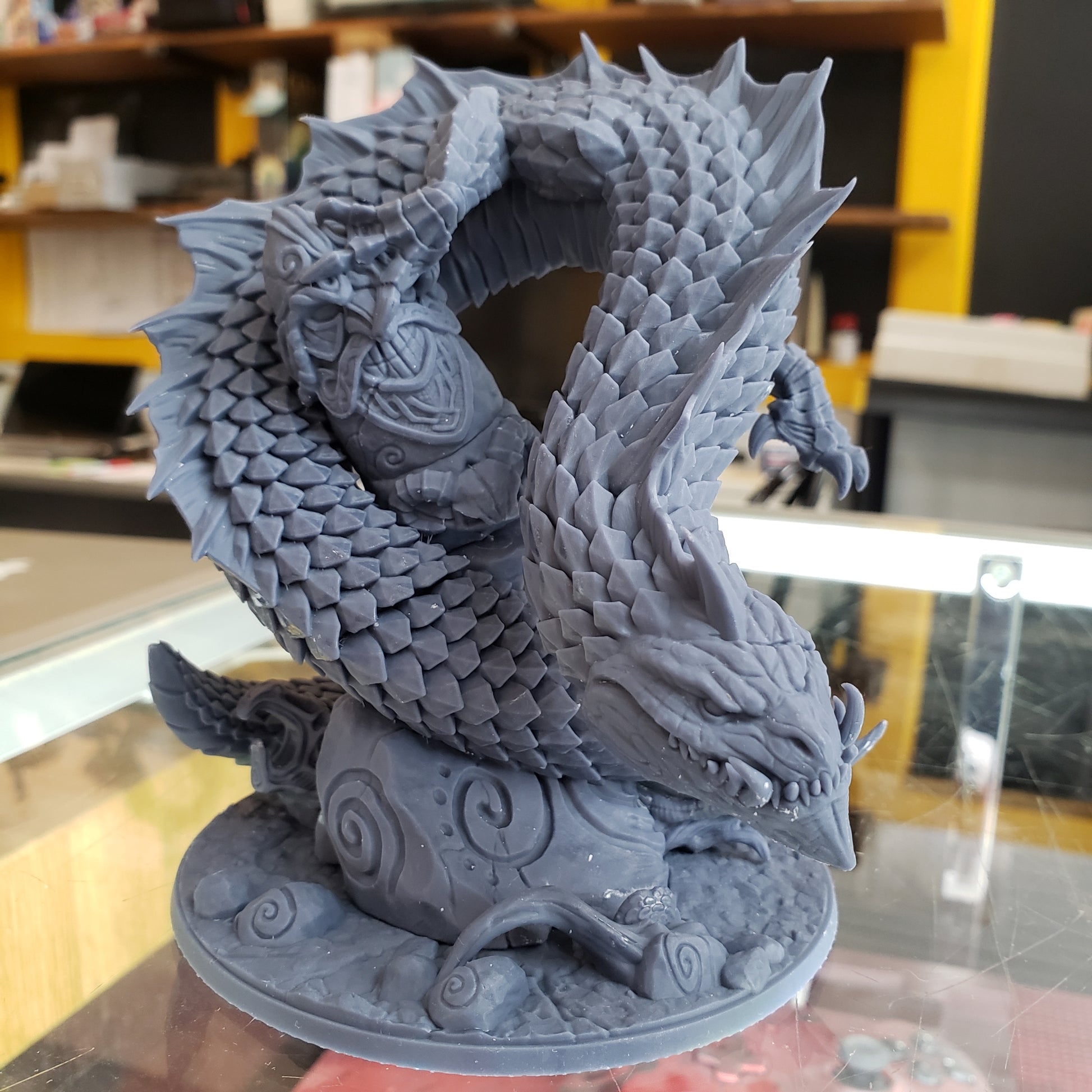 Image shows an example of a 3D printed snake-like dragon gaming miniature printed in-house at All Systems Go
